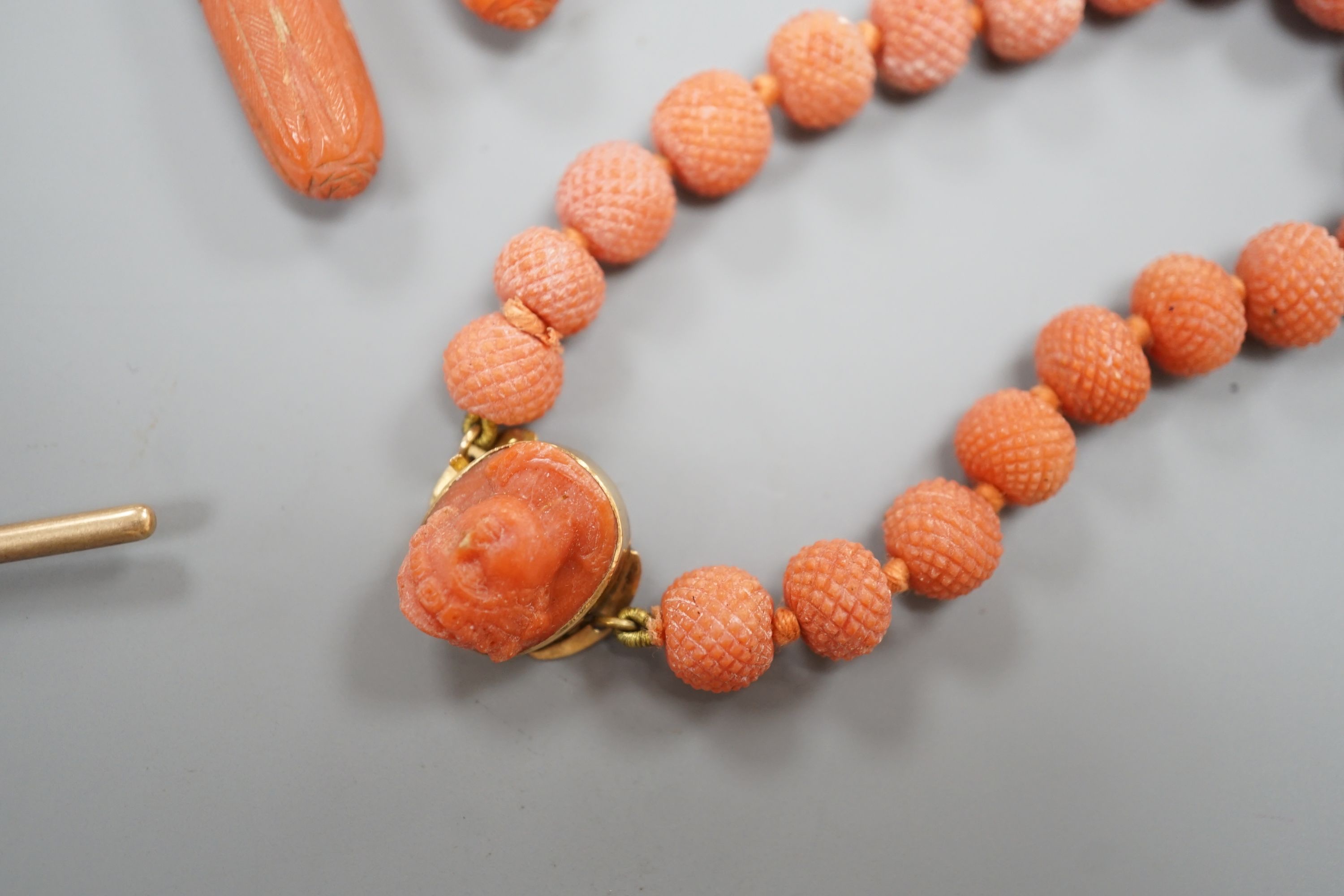 A pair of 9ct mounted teardrop shaped carved coral drop earrings, 6cm, gross 14.7 grams, a carved coral bead bracelet with yellow metal and carved coral bust set clasp, gross 20.5 grams and four other items including a 9